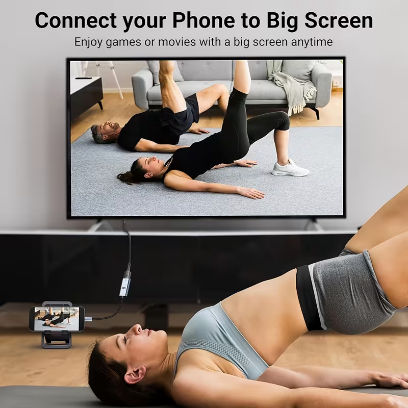Phone connected to a TV through the adapter, mirroring to the big screen